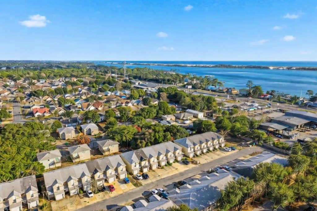 Aerial view of Mary Esther, FL: Keystone townhomes, Highway 98, and the Sound