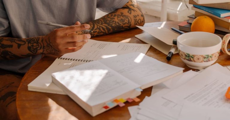 Person working through paperwork at a table
