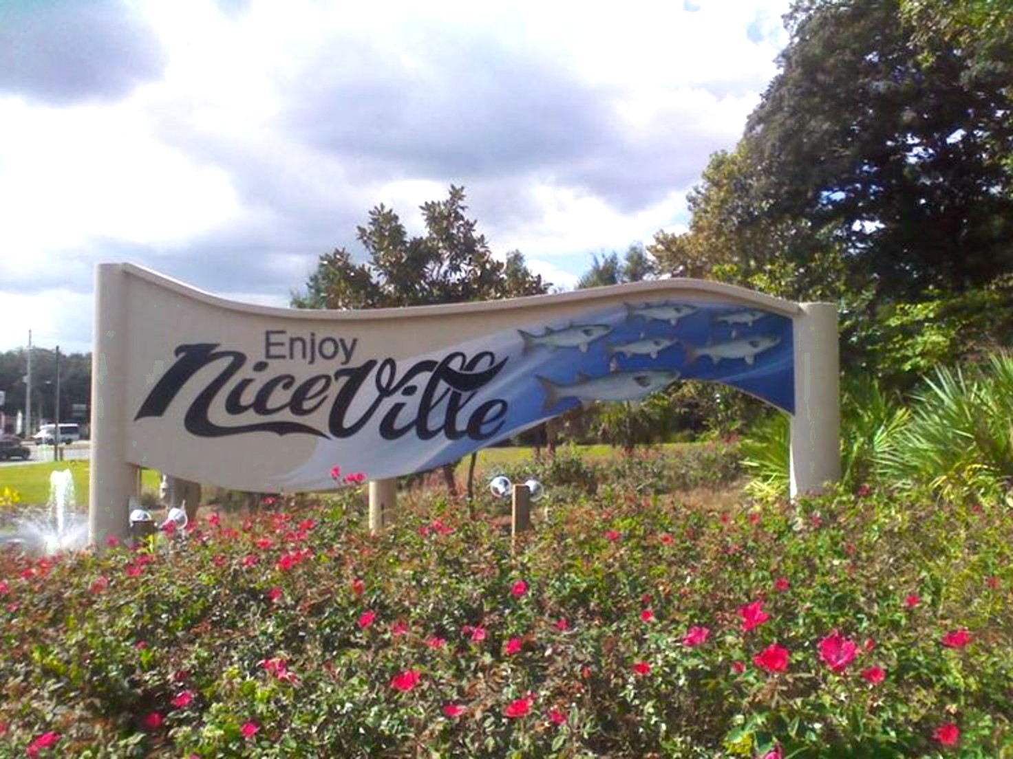 Enjoy Niceville welcome sign surrounded by pink roses in Niceville, Florida