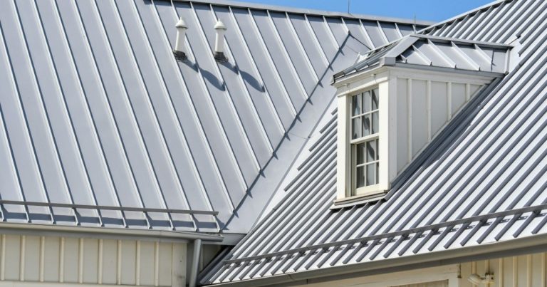 Gray standing seam metal roof with a dormer window