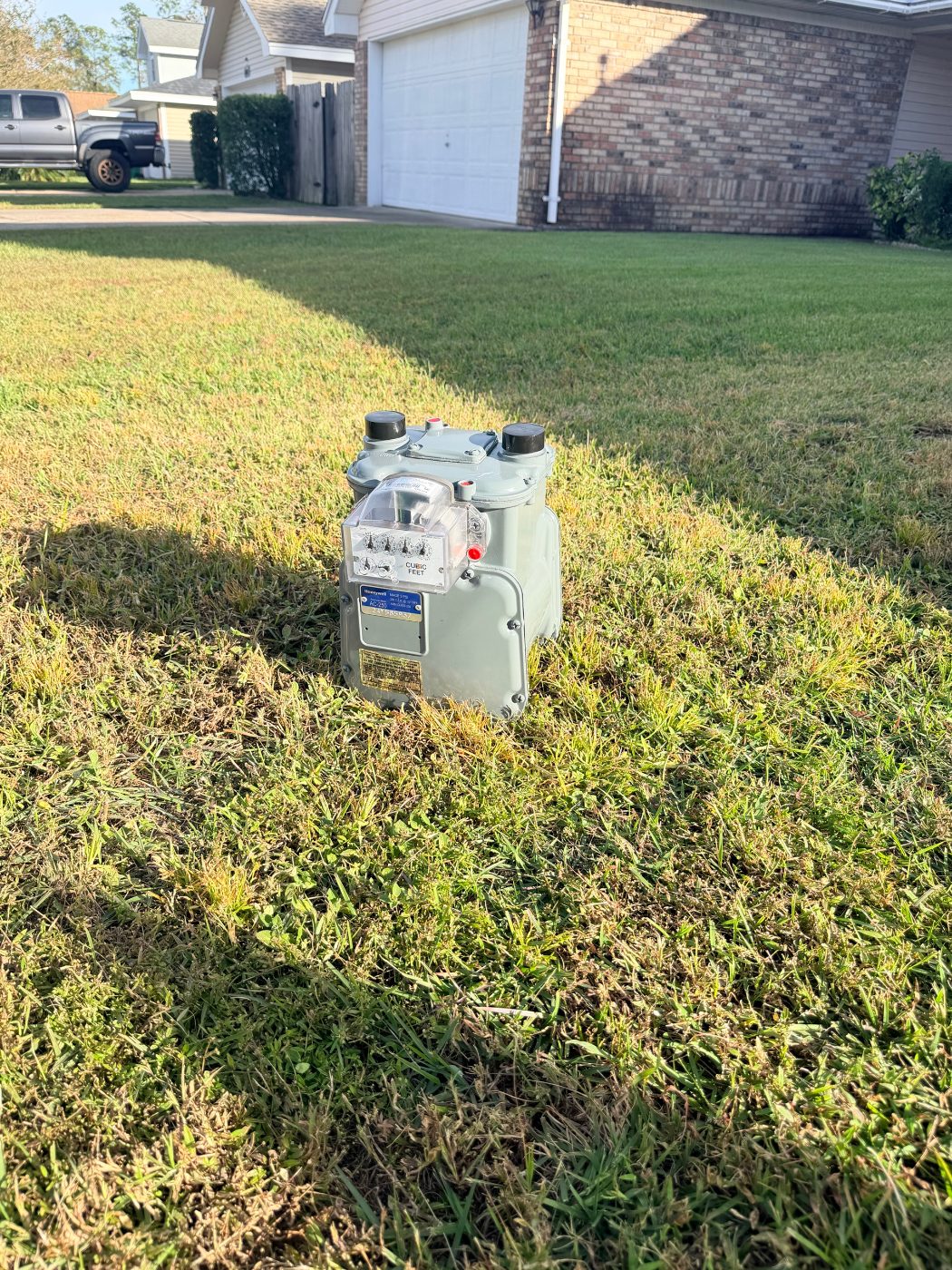 Brand-new gas meter waiting on the lawn to be installed