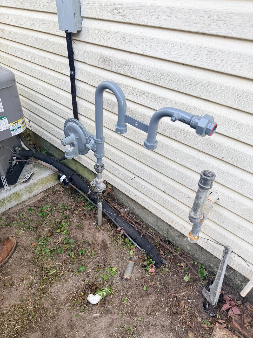 New gas piping and regulator installed on the side of the house