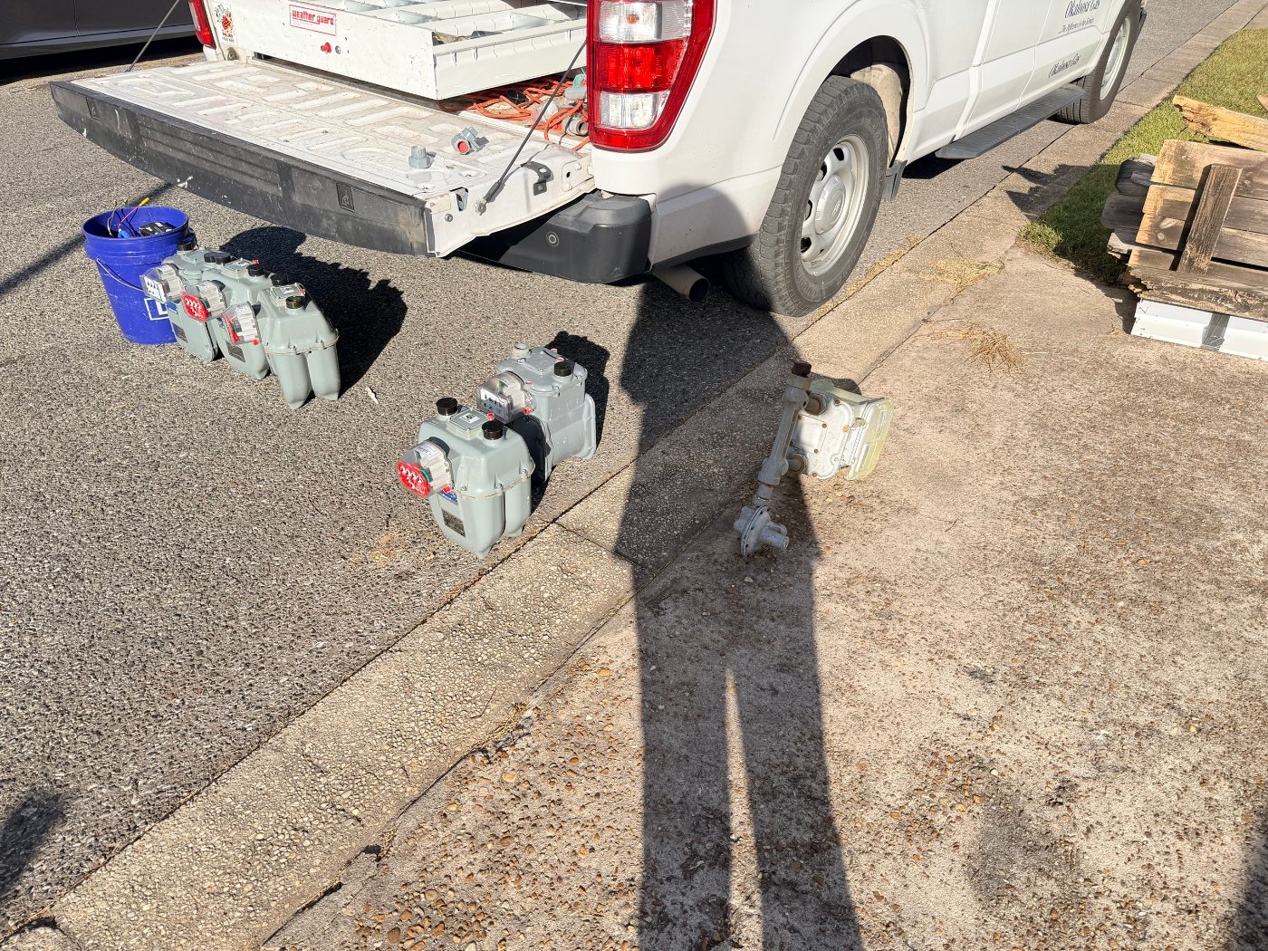 Okaloosa Gas service truck with new gas meters lined up on the curb